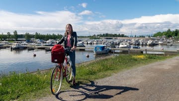 A girl is cycling in the sunny Vaasa